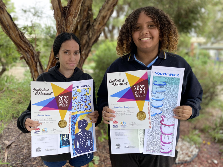 Two students holding 2025 youth week outstanding achievement awards and also holding their artworks